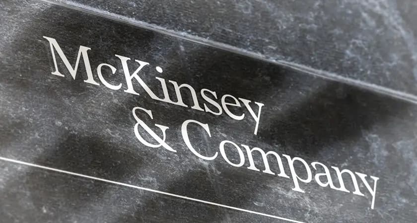 The name McKinsey & Company engraved in white lettering on a dark stone wall.